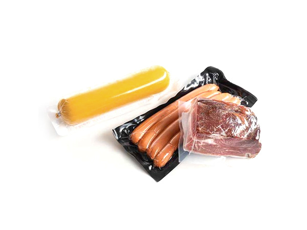 Thermoforming vacuum packaging machine with mechanical arm