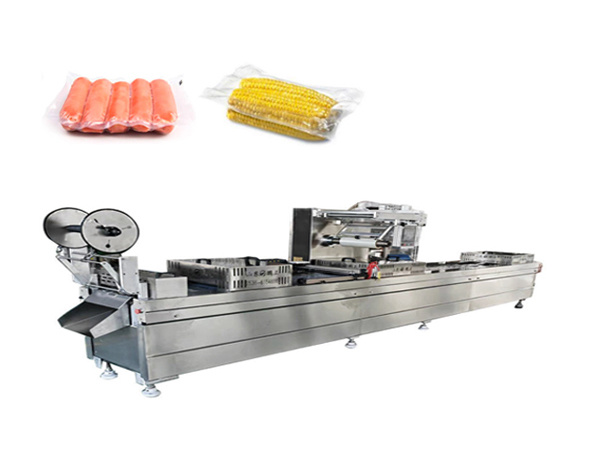 Thermoforming vacuum packaging machine with mechanical arm
