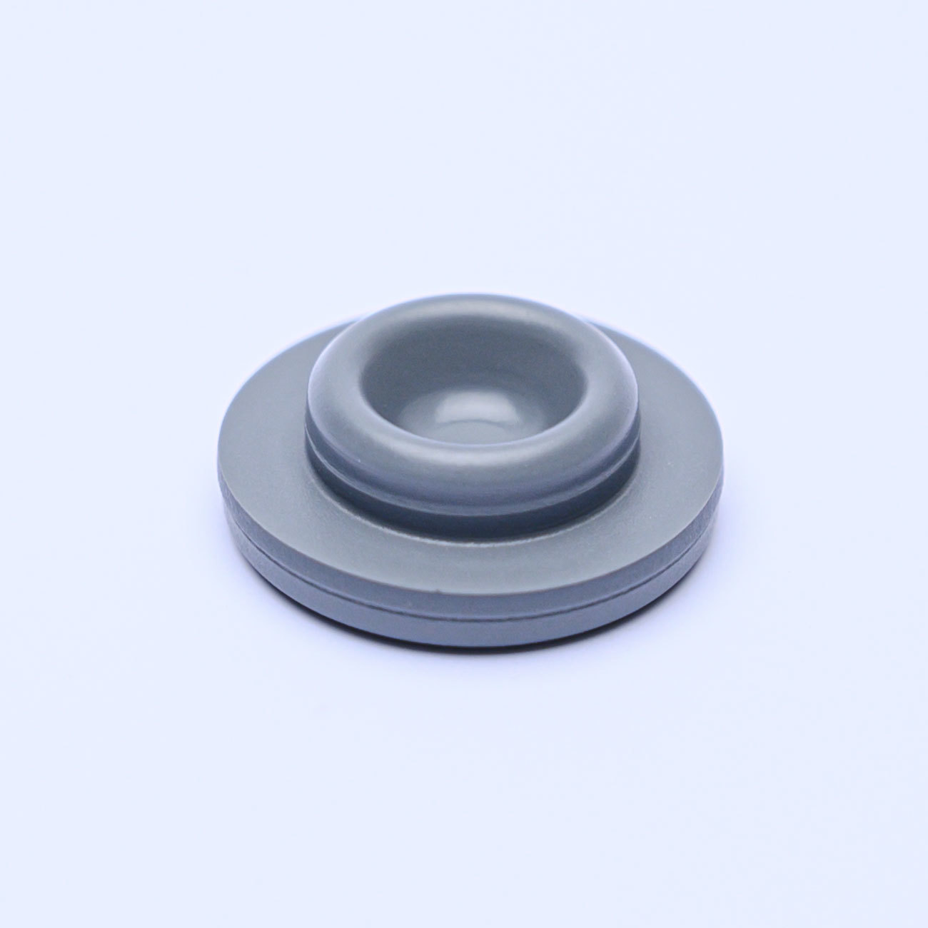 Film-coated rubber stopper for sterile powder for injection