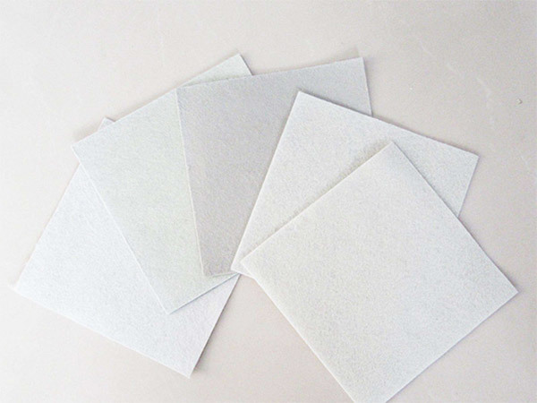 Short filament composite geomembrane