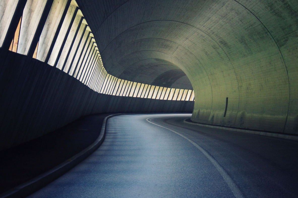 What are the four stages in the development history of shield tunnels at home and abroad?
