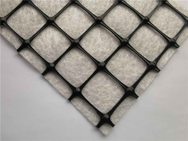 Geogrid-nonwoven geocomposite
