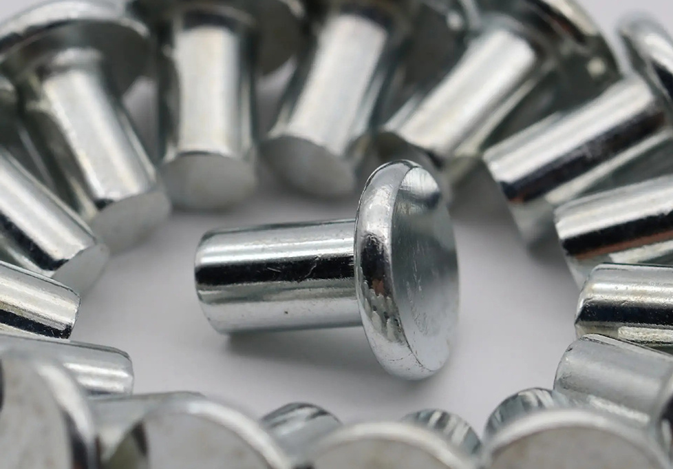 What is the difference between a semi-hollow rivet and a solid rivet?
