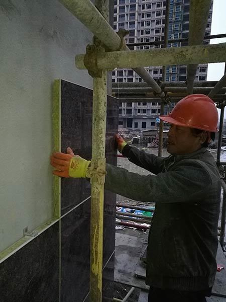 Workers are installing insulation boards