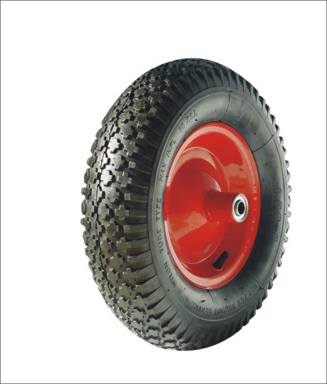 Anti-slip block pattern tread metal bearing pneumatic wheel.