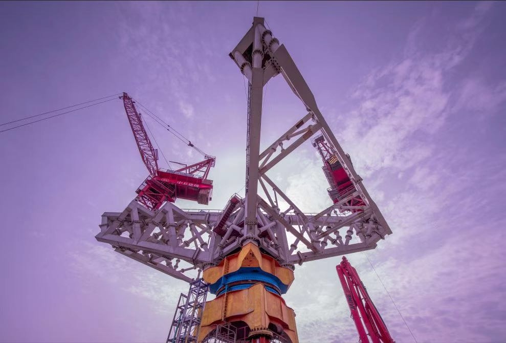 Multiple cranes rotate the platform