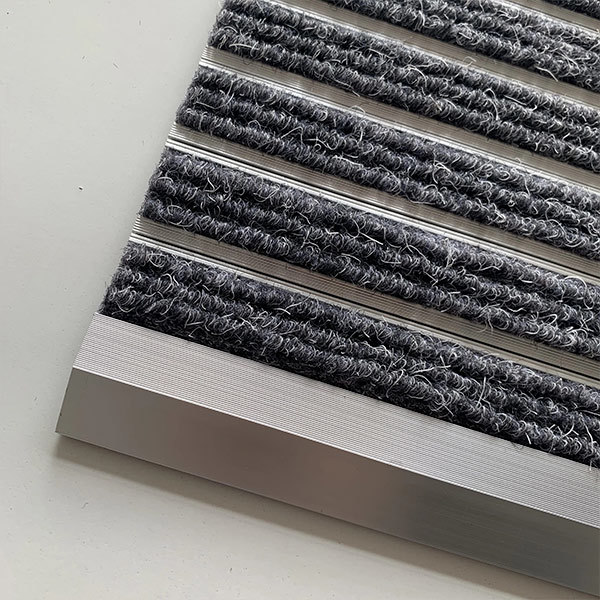 Why does ALMAT Carpet claim to specialize in producing aluminum  floor mats?
