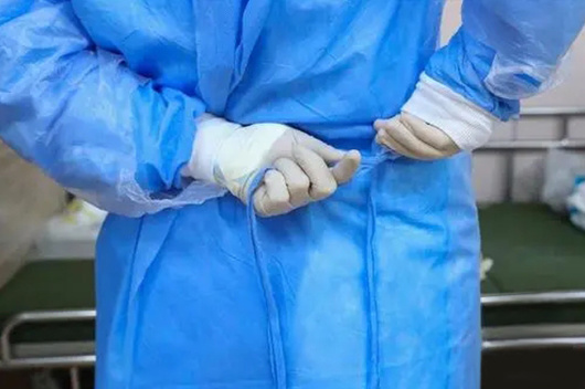 Disposable isolation gown put on and take off process