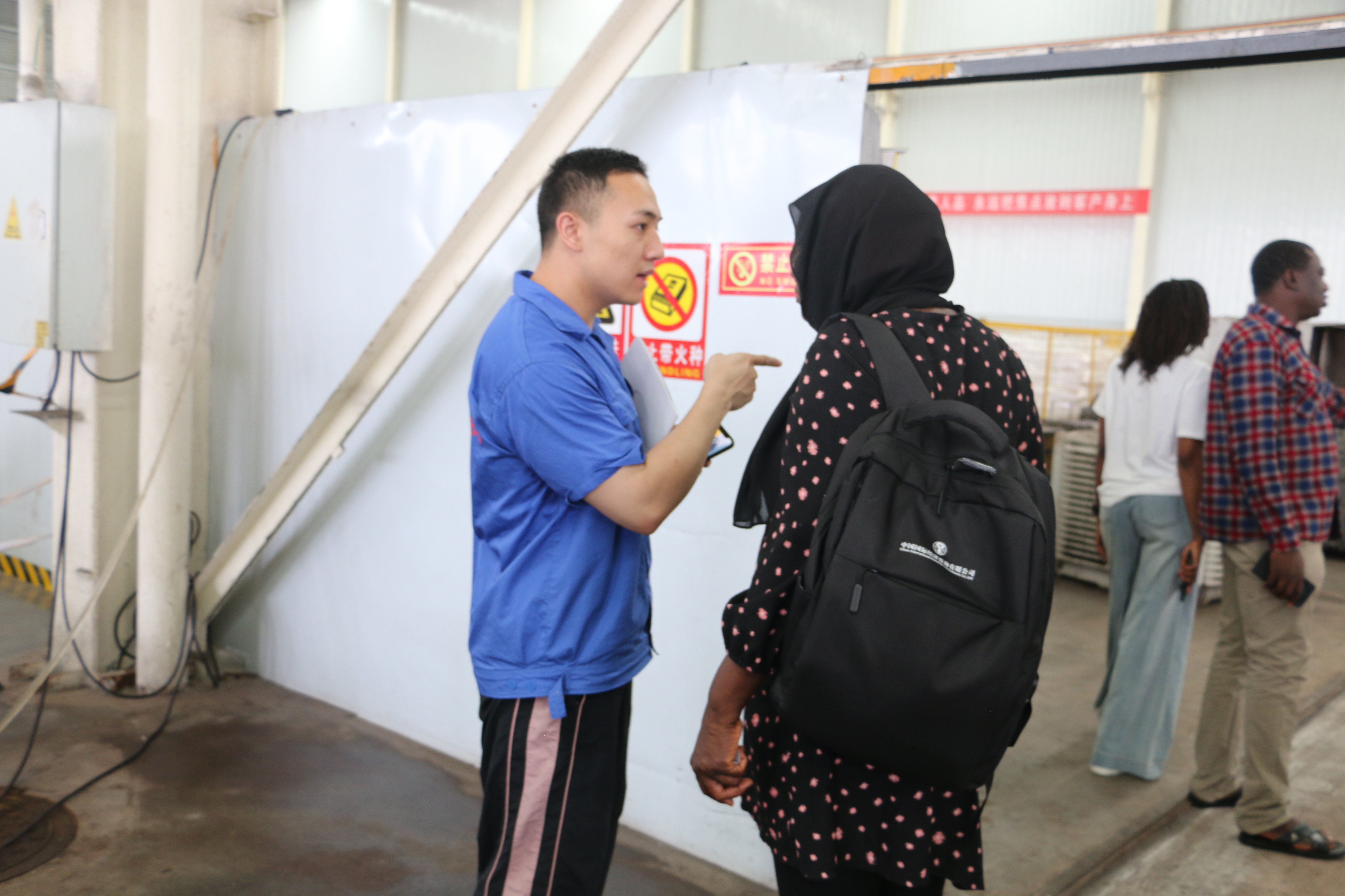 International rail clients observing the hot forging process of railway clips at Henan Xinda's manufacturing plant in China.