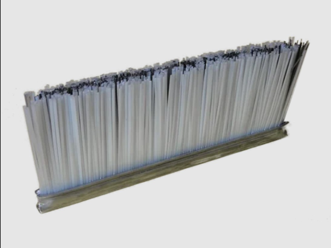 Strip brush for concrete block machine
