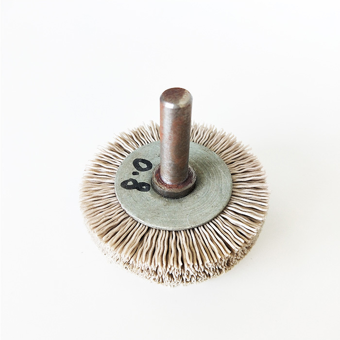 Tapered mandrel mounted brush