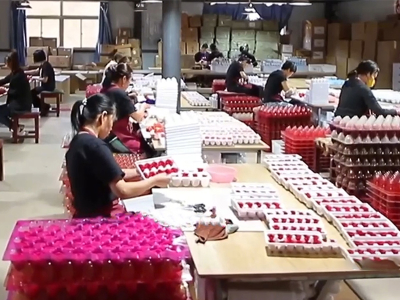 Technicians inspecting preserved roses for quality and consistency