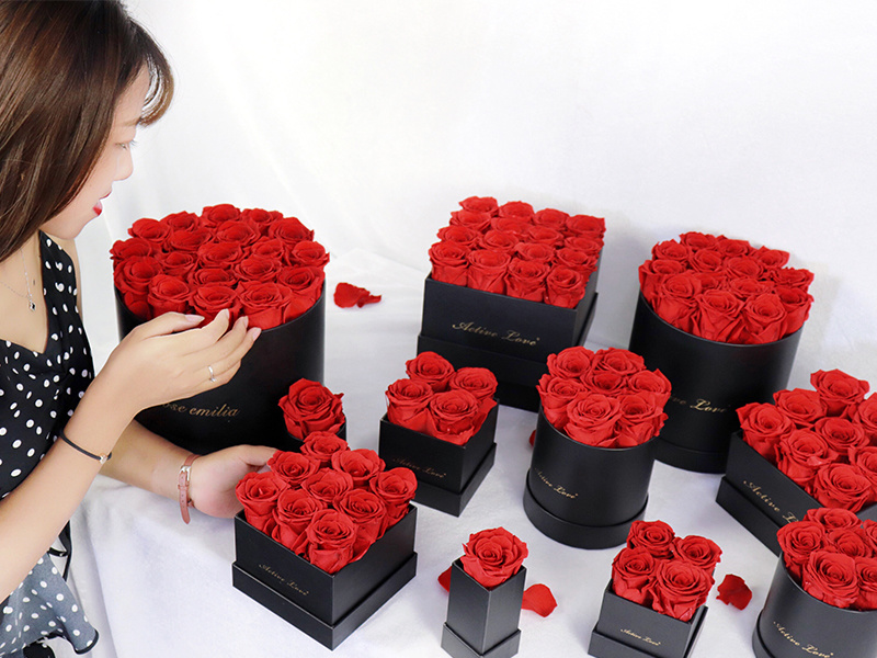 Red preserved roses in round and square gift boxes