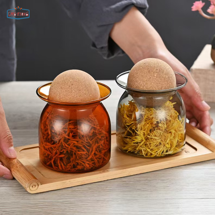 Kitchen glass food storage jars made of high-borosilicate glass, available in amber, gray, and coffee colors, with sealed lids and cork stoppers.