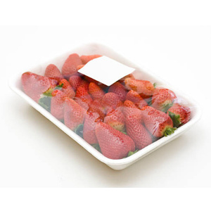 Strawberries in trays are packed under plastic wrap