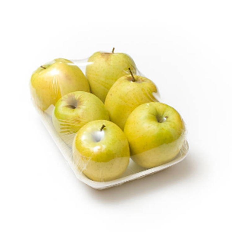 Pears in trays are packed under plastic wrap
